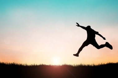 Mutlu yıllar 2022 konsepti. Özgürce ve mutlu atlayan bir adamın silüeti..