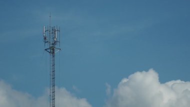 A large communication tower in the background is the sky. 
