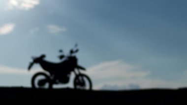 Silhouette of motorcycle with sunset background