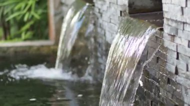 water flowing through the pond on background