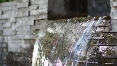water flowing through the pond on background