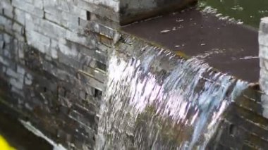 water flowing through the pond on background