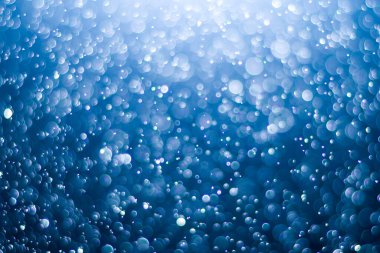 Bokeh 'in koyu mavi soyut arka planı. Renkli yanıp sönen ışıklar ışık arkaplanını tıkıyor.