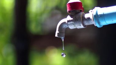 Slow motion video of water flowing out of the faucet