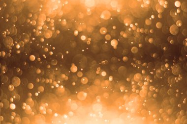 Altın arka plan. Soyut altın arkaplan. Şenlikli Altın Noel Arkaplanı. Arkaplan altın ışıkla parıldıyor, bokeh sönmüş ışık.