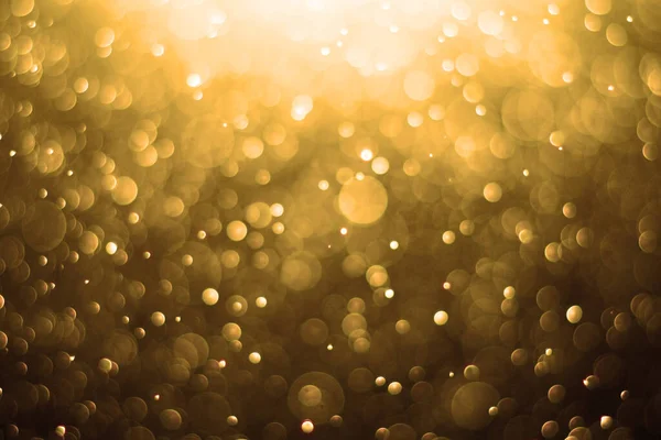 黄金の背景 抽象金の背景 黄金のクリスマスの背景背景は金色の光で輝いています ボケ焦点を当てた光 — ストック写真