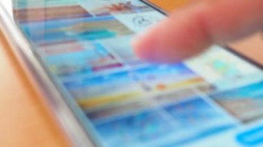 side view Man's hand using smartphone in coffee shop to search for information