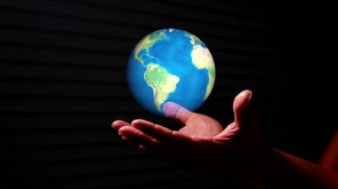 hand holding virtual globe on hand against black background. Digital world and information communication