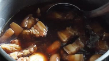 Stewed eggs and pork belly in a hot pot. home cooking ideas