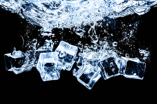 Ice cubes in water on studio dark background. The concept of freshness with coolness from ice cubes.