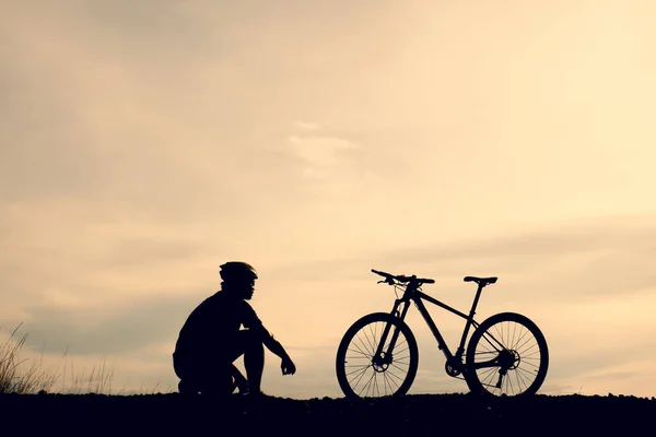 Silhouettes of mountain bikes and cyclists in the evening happily. Travel and fitness concept