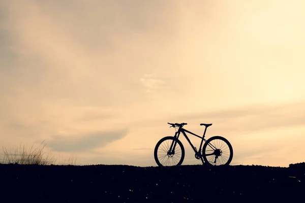 Silhouettes of mountain bike in the evening . Travel and fitness concept