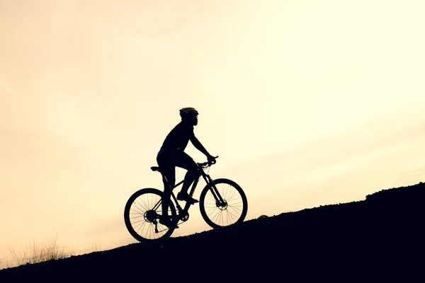 Silhouettes of mountain bikes and cyclists in the evening happily. Travel and fitness concept