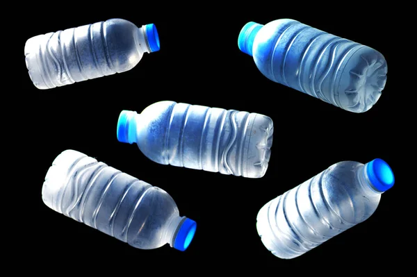 Trash plastic water bottles on black background. plastic waste problem