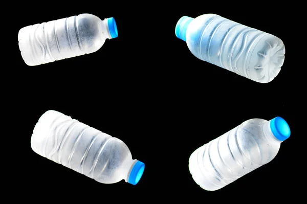 Trash plastic water bottles on black background. plastic waste problem