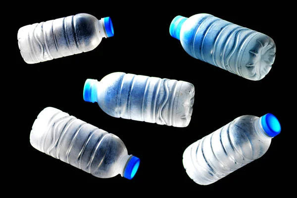 Trash plastic water bottles on black background. plastic waste problem