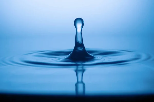 Drops of water and splashes. Blue splash water drop, round water drop, water drop in glass, drop, splash, spray, abstract shape out of water . Water shape abstract background concept.