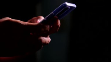 side view Man's hands using smartphone to search for information