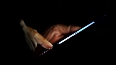 side view Man's hands using smartphone to search for information