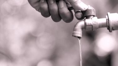 The concept of water crisis and despair from lack of clean water caused by drought. The faucet has no running water.