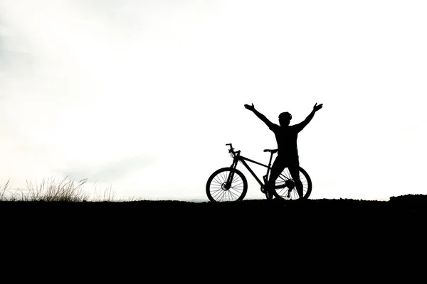 Silhouettes of cyclist and  mountain bike and cyclist. Travel and fitness concept