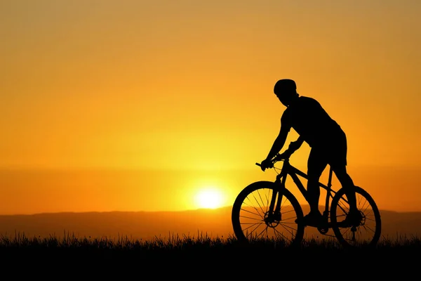 Silhouettes of cyclist and bike exercise at the sunset. travel concept