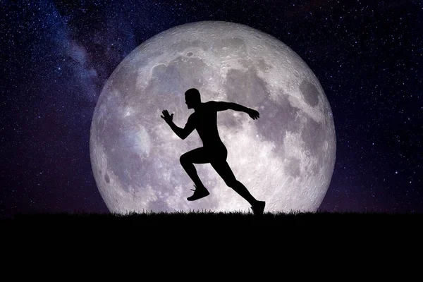 Man running against moon in the background at night.