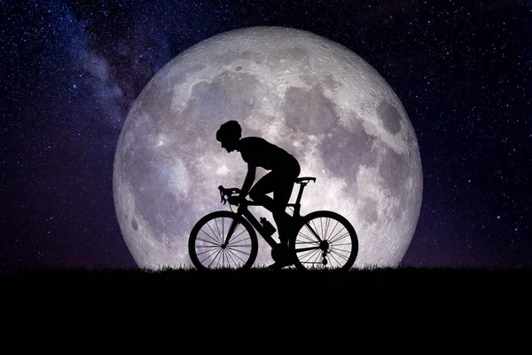man with bicycle with the moon in the background