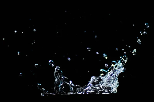 Splashing water on a black background. water droplets scattered on a black background