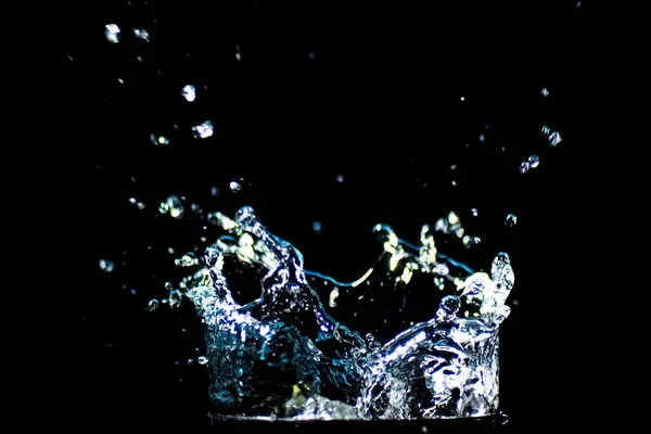 Splashing water on a black background. water droplets scattered on a black background