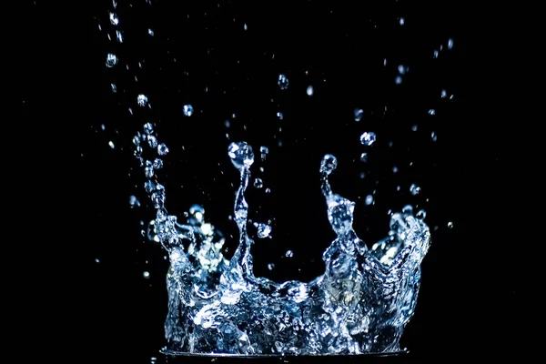 Splashing water on a black background. water droplets scattered on a black background