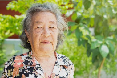 old asian woman face with freckles and wrinkles