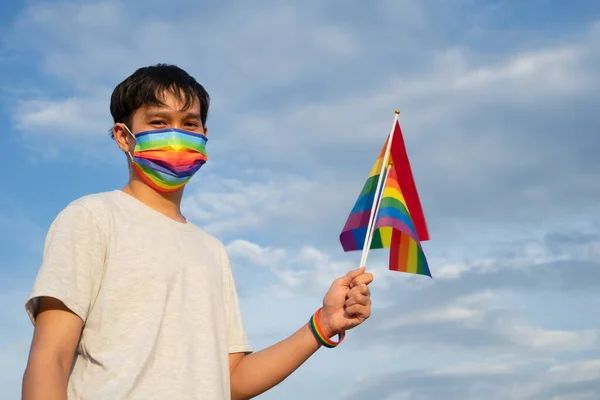 Young Asian Man Wears Medical Face Mask Wristband Rainbow Color — Stock Photo, Image