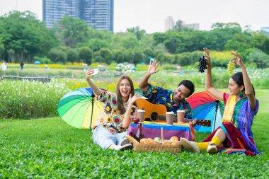 group of lgbt friends meeting and having a picnic on vacation,young asian lgbtq in colorful lgbtq symbol dresses doing selfie joyfully in the park, concept of lgbtq lifestyle,life,lgbtq community