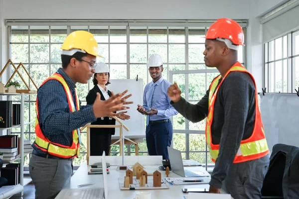 business engineering project manager looking at the coworkers having quarrel during a meeting in the office,selective focus at managers.concept of conflicts,  managing and resolving conflicts in the workplace