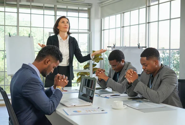 business partnership team pray to spiritual growth for successful of business during meeting.concept spiritual life with business(selective focus at a woman)