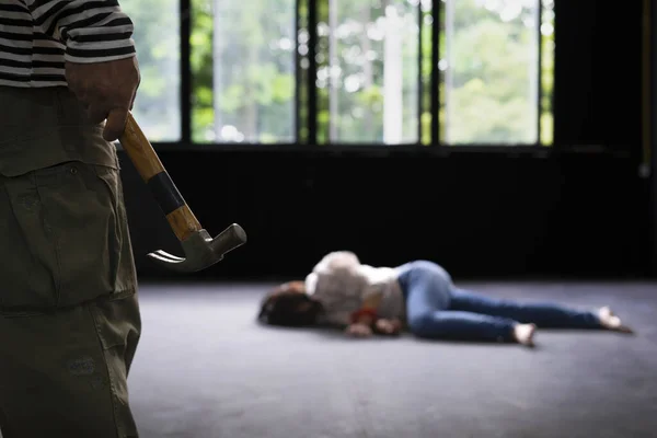 killer holding hammer walk to the victim who being tied lying on the floor in  abandoned house