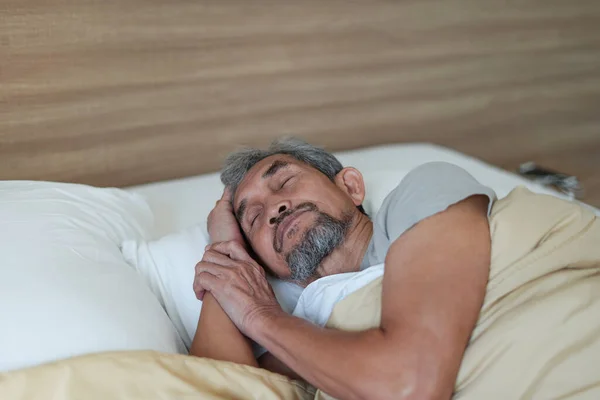 senior man asleep on the bed,older adult asian man sleeping comfortably in blanket. concept elderly people lifestyle, get enough rest,health care