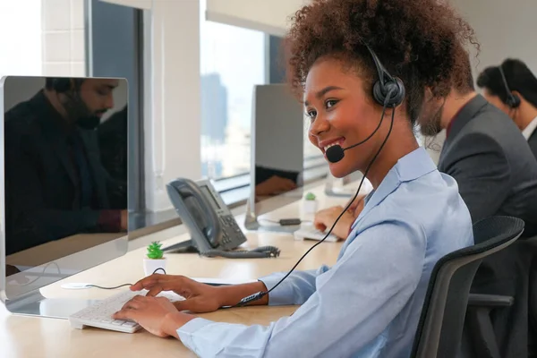 portrait the african american female wear headsets is working in a call centre, business woman operator agent is answering phone online