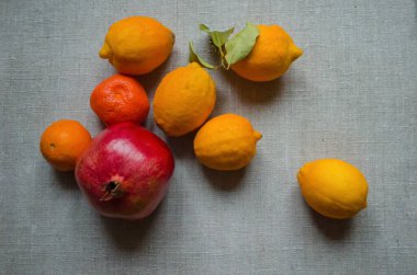 Fruits bergamot, pomegranate, lemon, pamelo, pear, tangerine, mango on a wooden background. Vitamin still life.