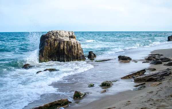 Turquoise shallow water surface and rocks stones on sea floor. Shallow transparent sea water rocks at the bottom