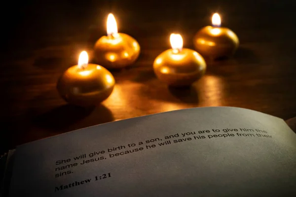 christmas bible verse with candles on the background