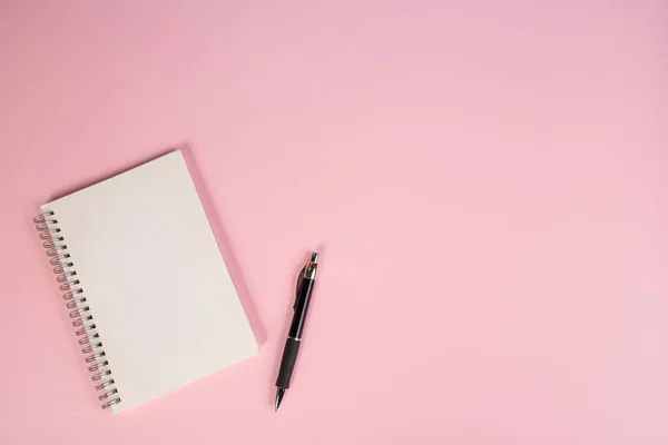 Ένα Σημειωματάριο Και Ένα Στυλό Ροζ Επιφάνεια — Φωτογραφία Αρχείου