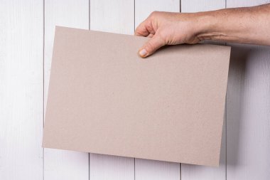 a cardboard sign held in hand