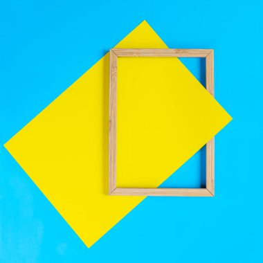 a wooden frame on a background of colored shapes