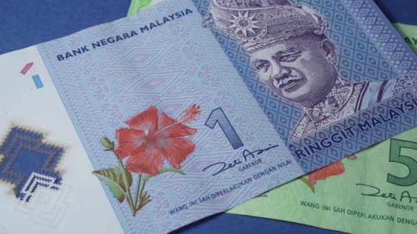 Scrolling Some Malaysia Banknotes Blue Surface — Stock video