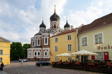 Tallinn, Estonia. July 2022.  The domes of the Alexander Nevsky Cathedral among the houses in the historic center of the city