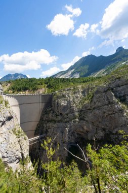 The Vajont disaster occurred on 9 October 1963, when a landslide broke off from Mount Toc and fell into the basin causing a wave that went over the dam and destroyed the town of Longarone, causing 2000 victims.
