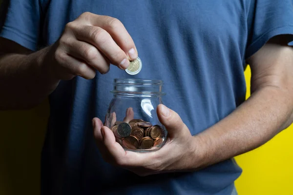 Man Saves Collecting Coins Glass Jar — Photo