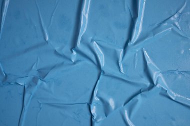 Bleu background. Wet and wrinkled sheet of paper. Background mockup.